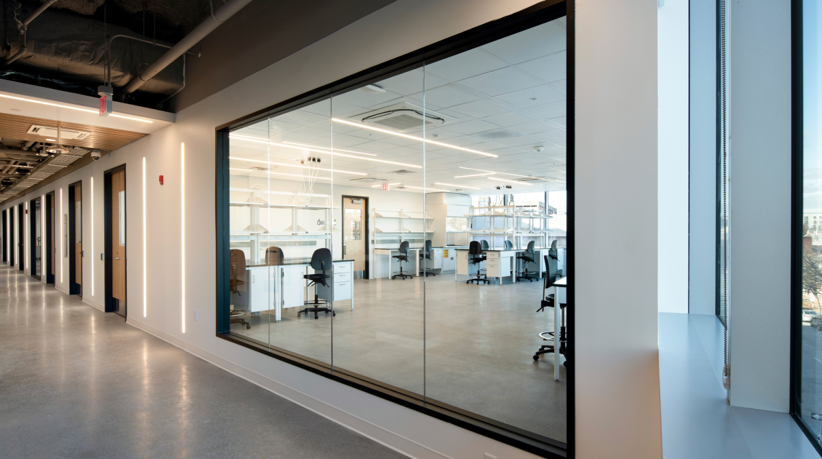 Hallway with a window that looks into an empty wet lab